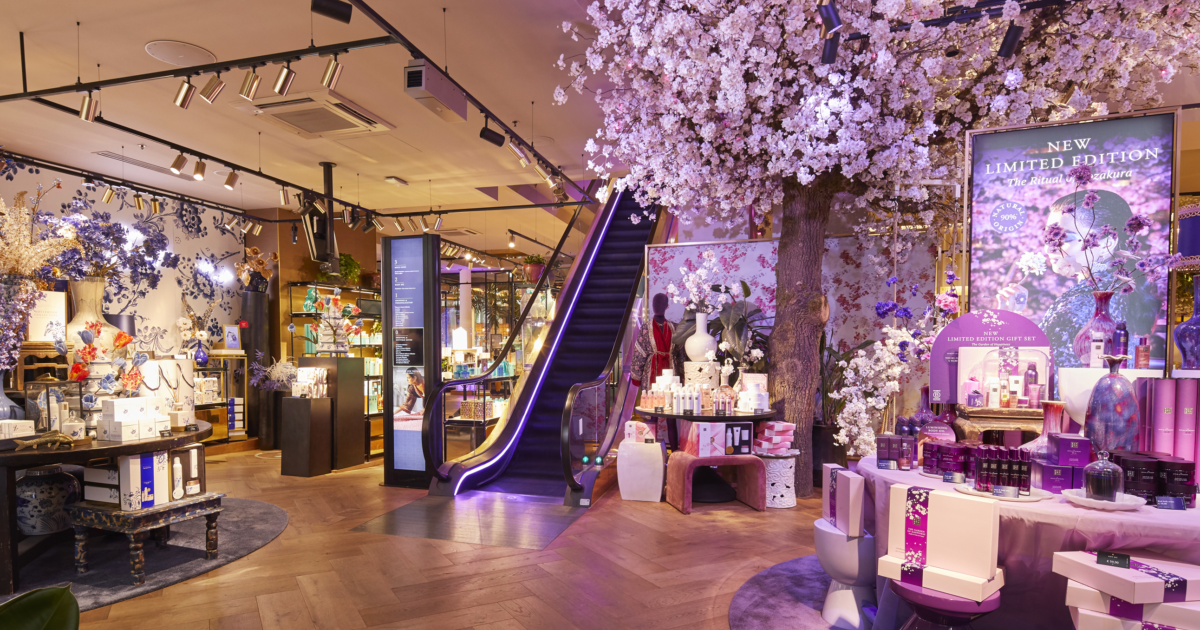 Immersive in-store display at House of Rituals with cherry blossom tree, escalator, and limited edition wellness products.